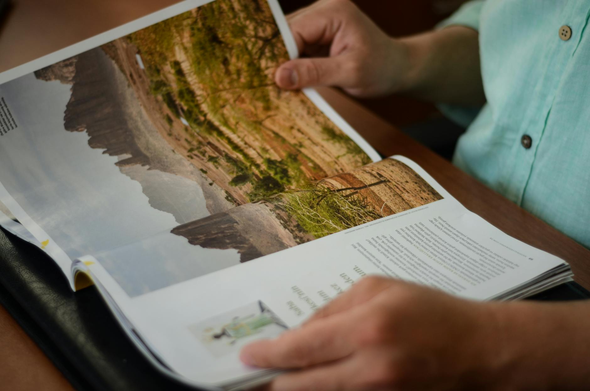A person reading printed pages closely under reading light — the kind of close attention a competitor brand audit actually requires.