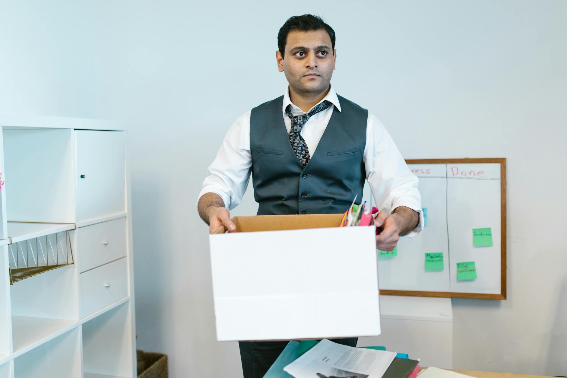 Moving boxes stacked in a transitional office space — the operating reality of a company in the weeks after a pivot.
