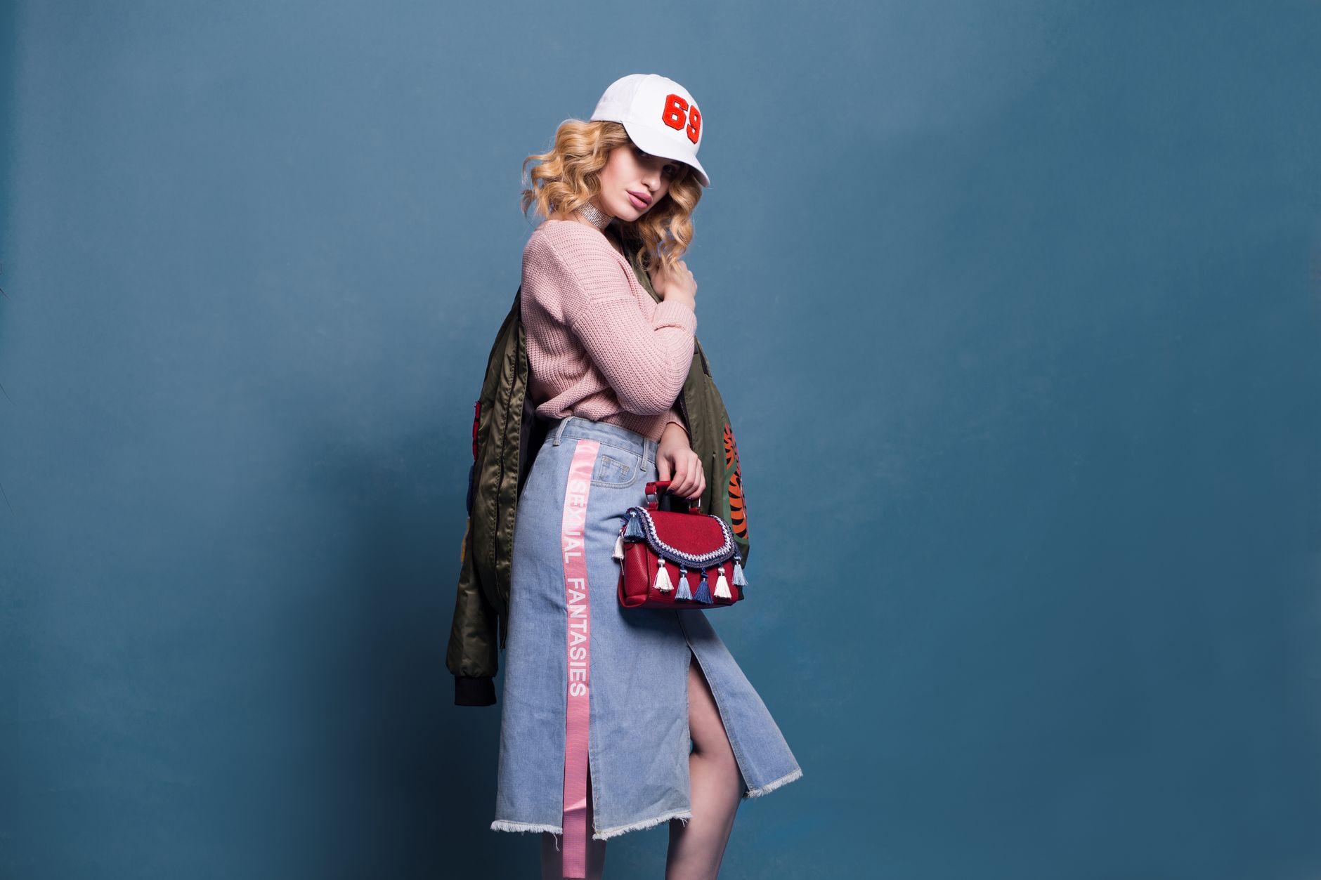 A fashion model posing in a studio, showcasing an outfit, in the style of a clothing campaign shot.
